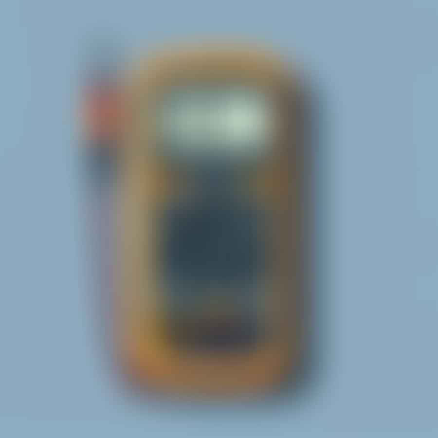 Multimeter being used to check the voltage of a car battery.